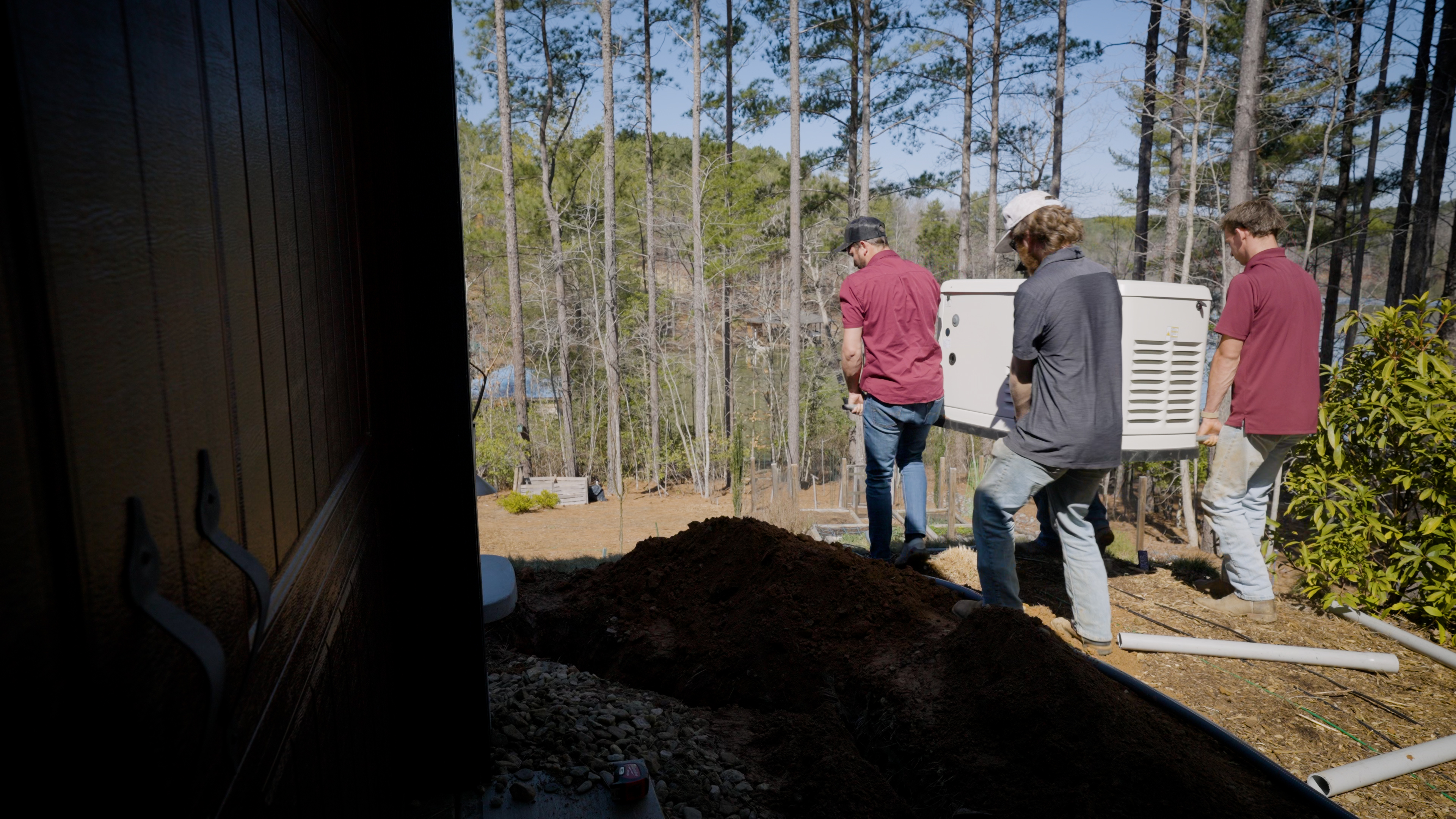 Electricians moving a standby generator unit for a Ballentine project