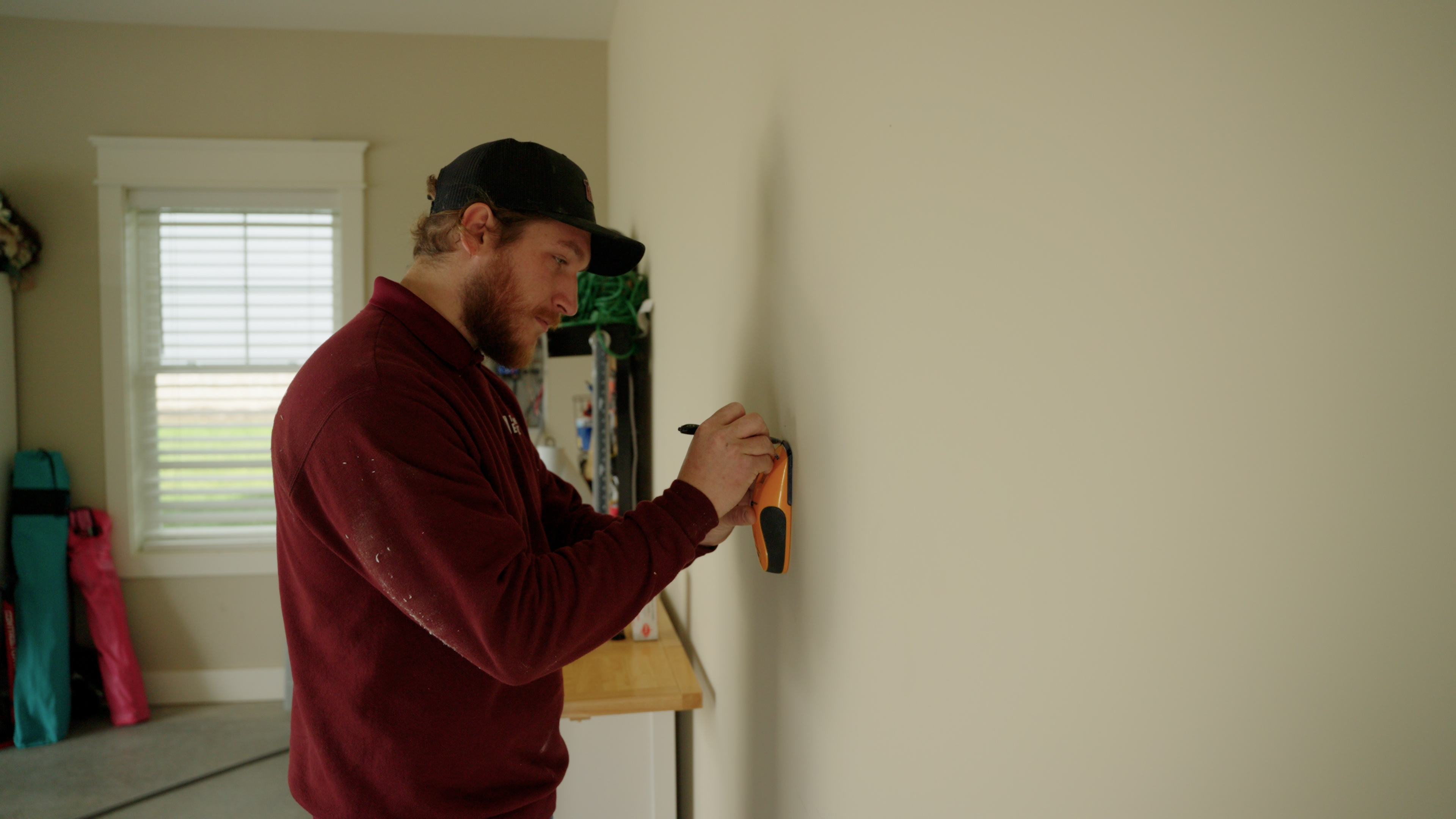 Electrician mounting an EV charger on a residential wall