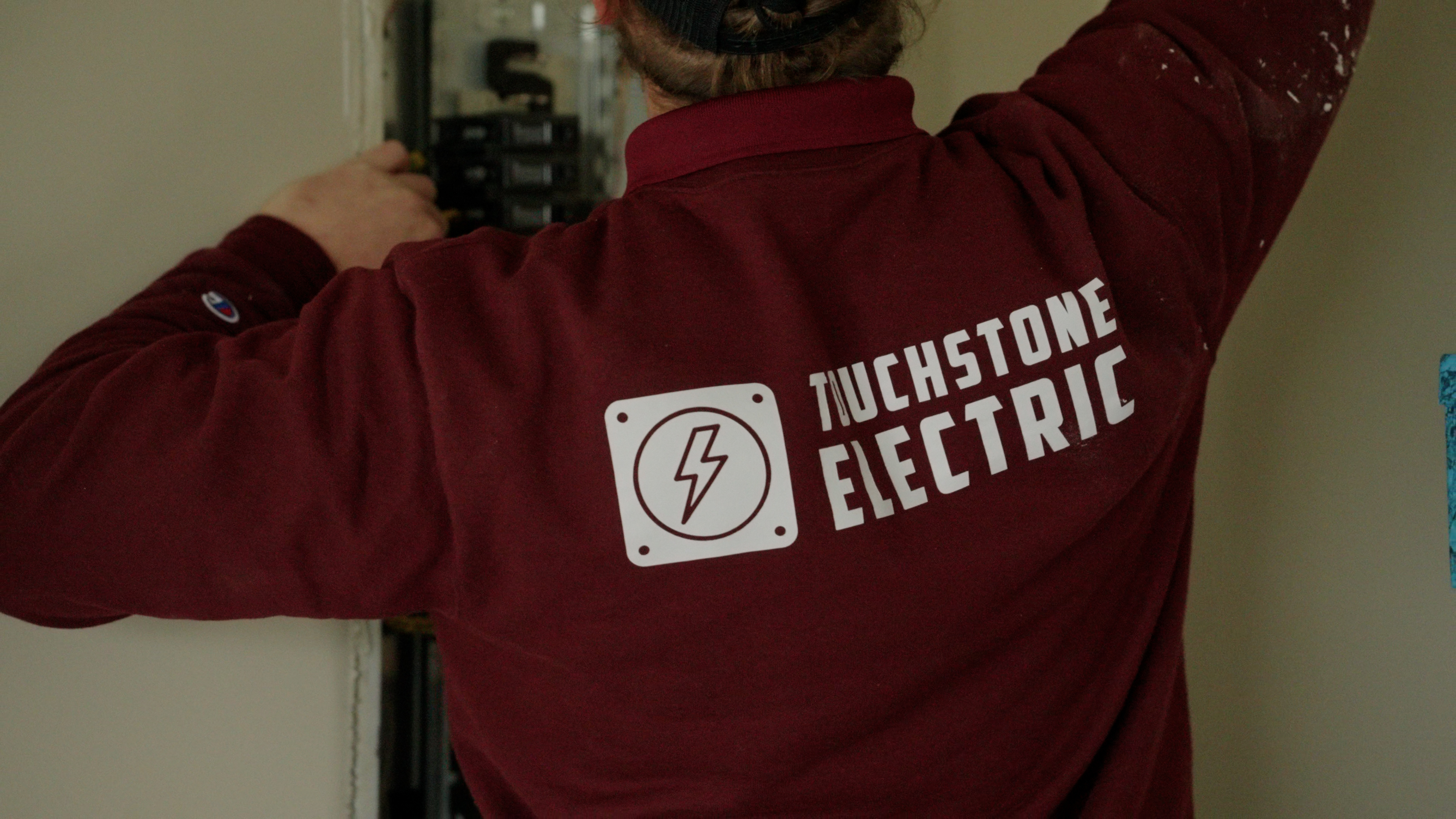 Touchstone Electric technicians installing residential service panel equipment